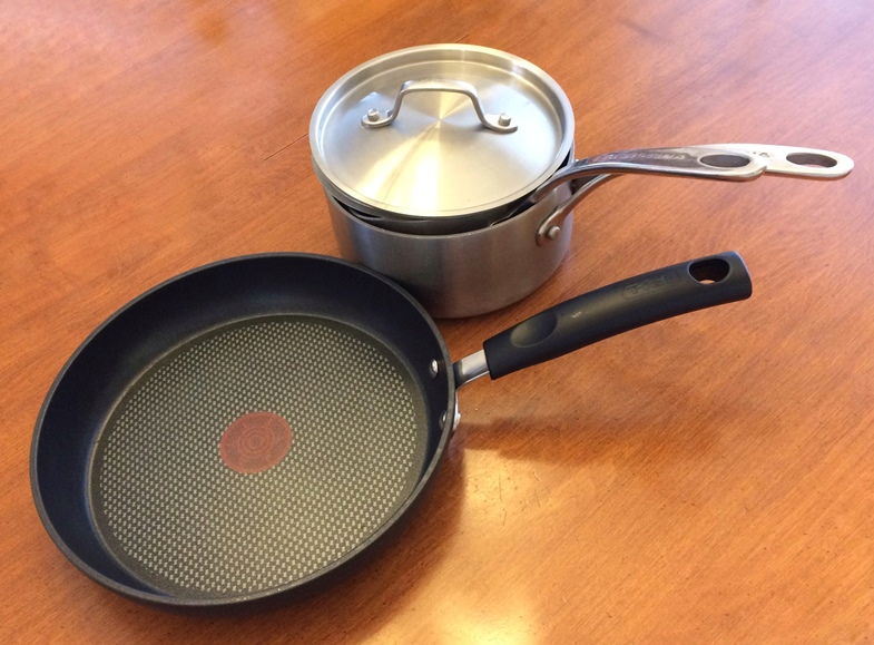  Photo of some pots and a nonstick frying pan. 